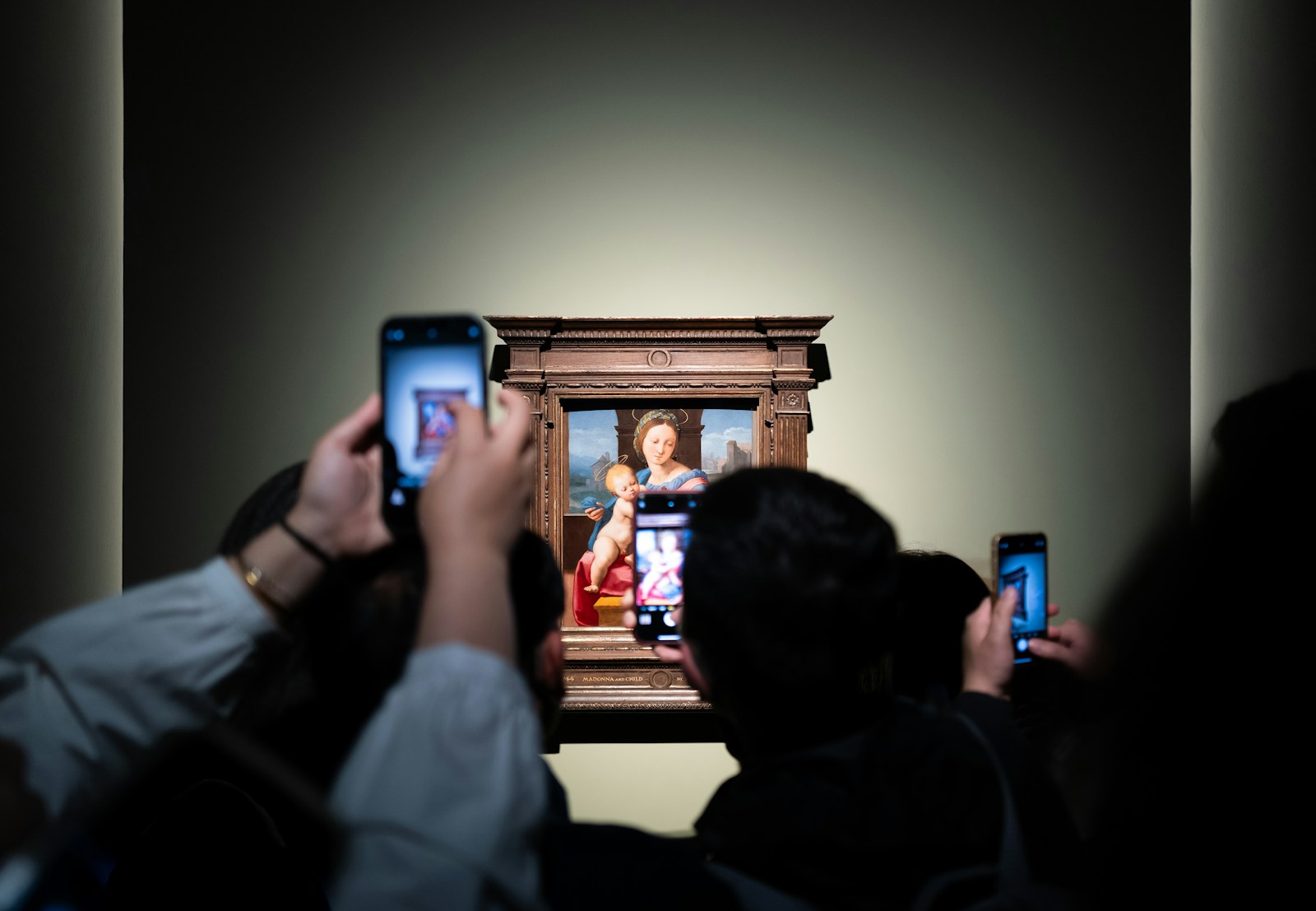 People take pictures of art at the gallery
