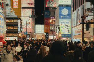 A crowded street in a city at night.