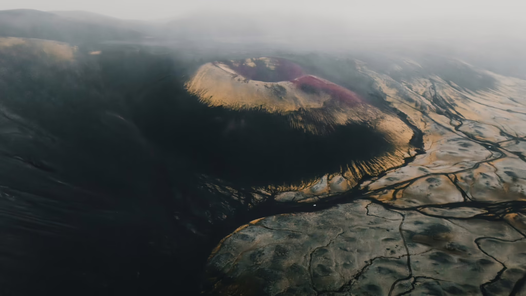 Aerial view of a volcanic crater with colorful mineral deposits
