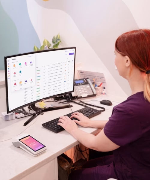 a woman sitting at a desk using a computer